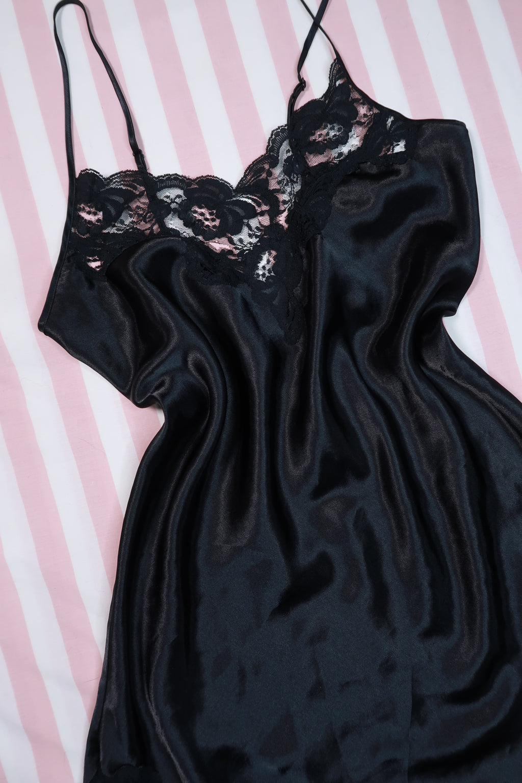 Vintage 80s black satin lace slip dress by Victoria’s Secret, styled with gold label and elegant lace details.