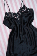 Vintage 80s black satin lace slip dress by Victoria’s Secret, styled with gold label and elegant lace details.
