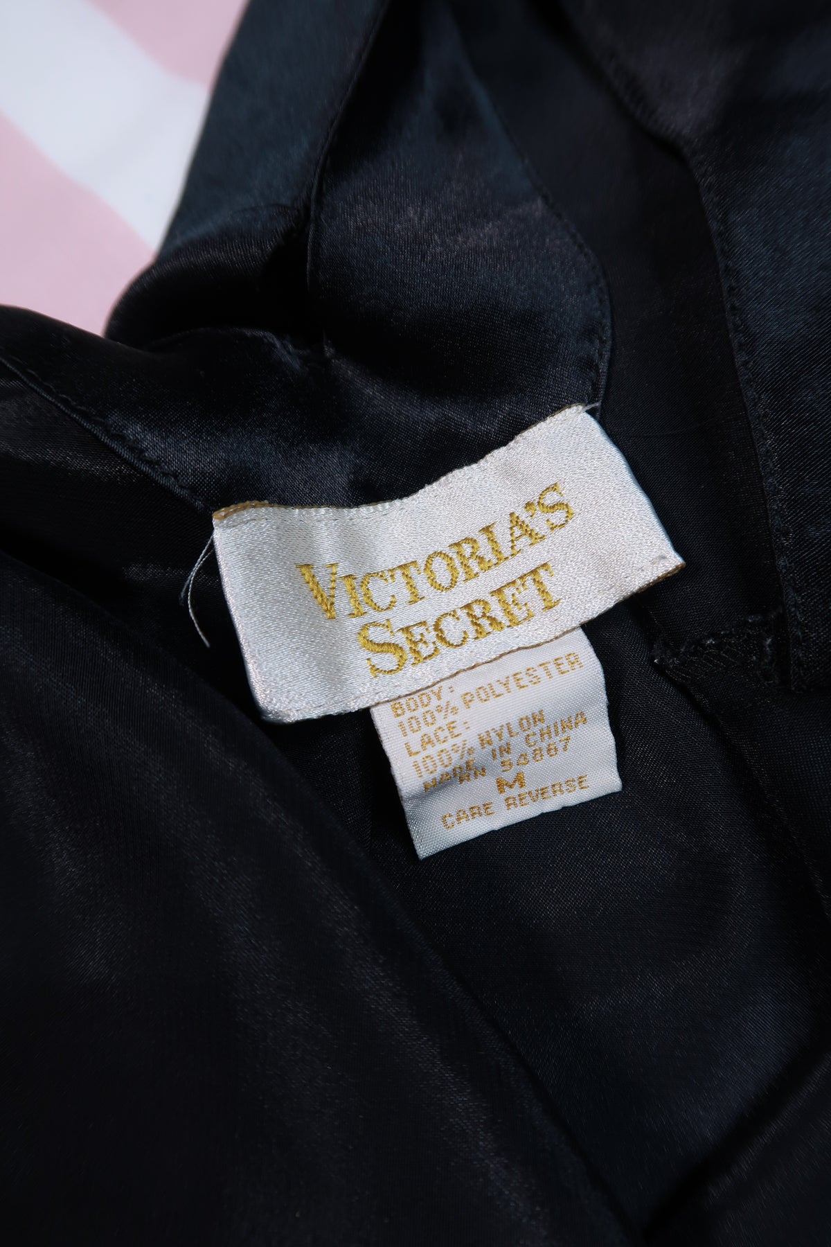 Vintage 80s Gold Label Victoria’s Secret black satin lace slip dress by Elektra Vintage, featuring delicate lace details and a sleek silhouette.