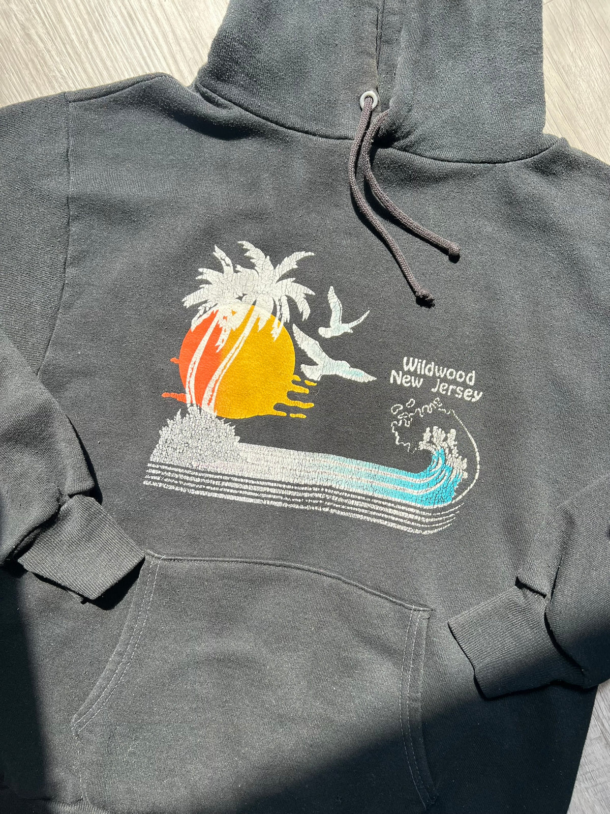 Black 80s Vintage Wildwood New Jersey hoodie by Russell, featuring retro style and classic branding, styled on a hanger.
