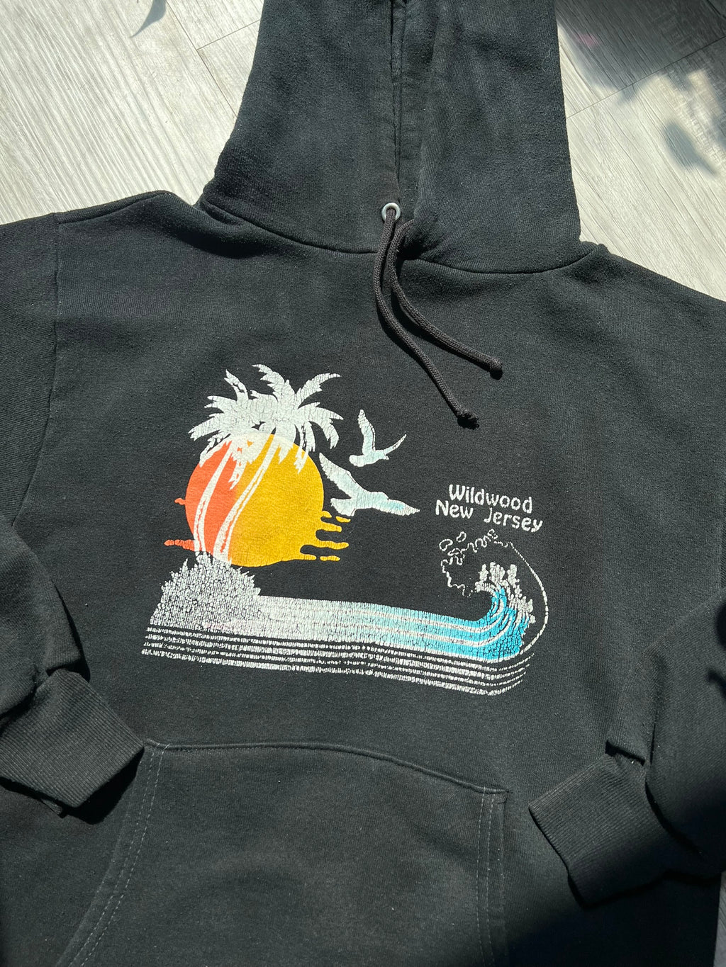 Black 80s Vintage Wildwood New Jersey hoodie by Russell, Elektra Vintage, featuring retro design and casual fit.