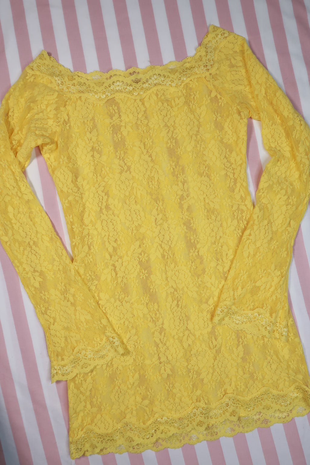 Elektra Vintage yellow lace off-shoulder dress with delicate detailing and flowing design showcased against a neutral backdrop.