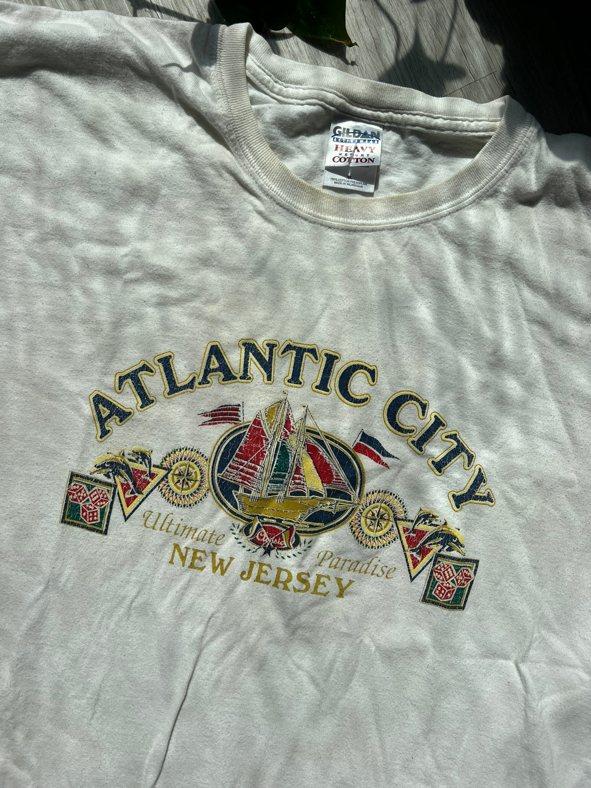 Vintage Atlantic City white Gildan T-shirt featuring retro logo design, displayed flat on a white background.