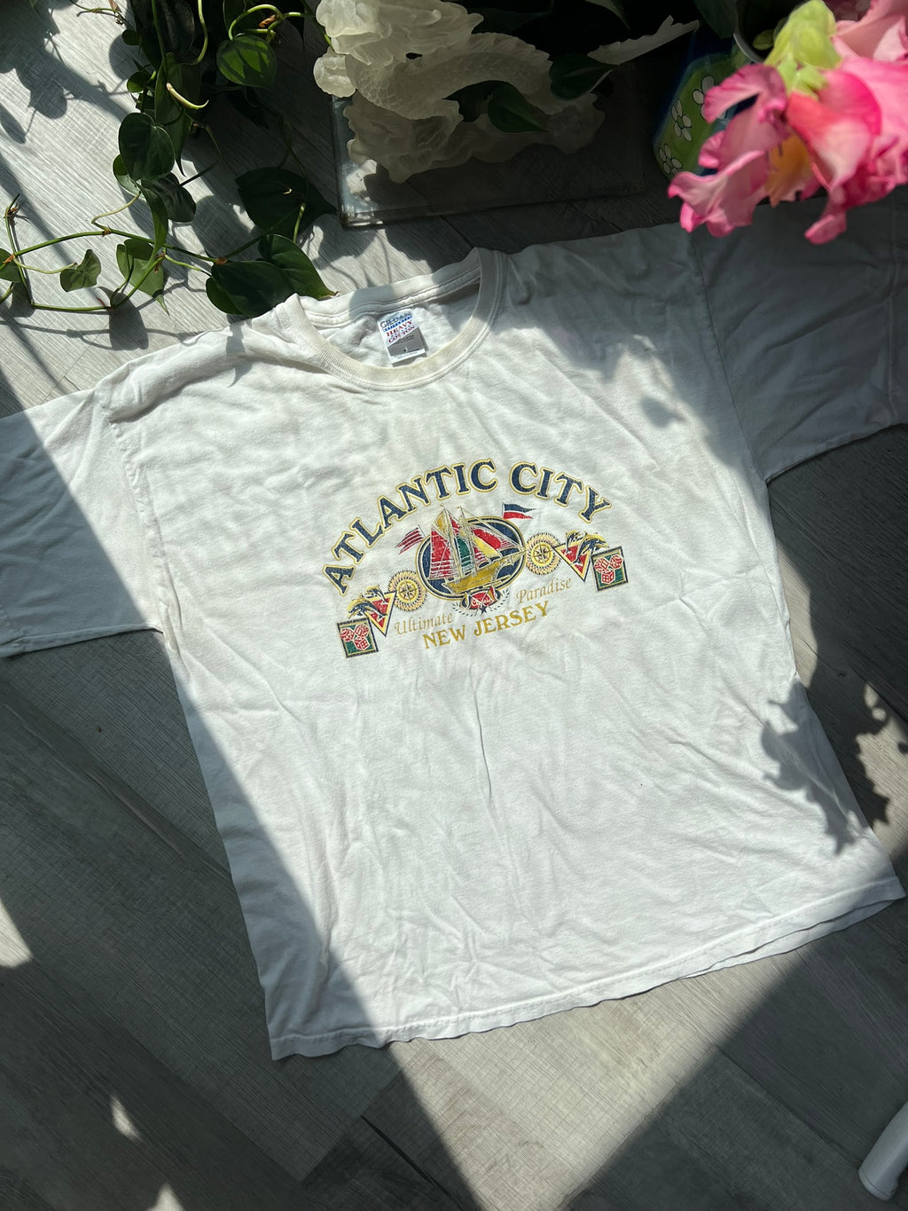 Vintage Atlantic City white T-shirt by Gildan, featuring classic design and Elektra Vintage branding, displayed on a hanger.