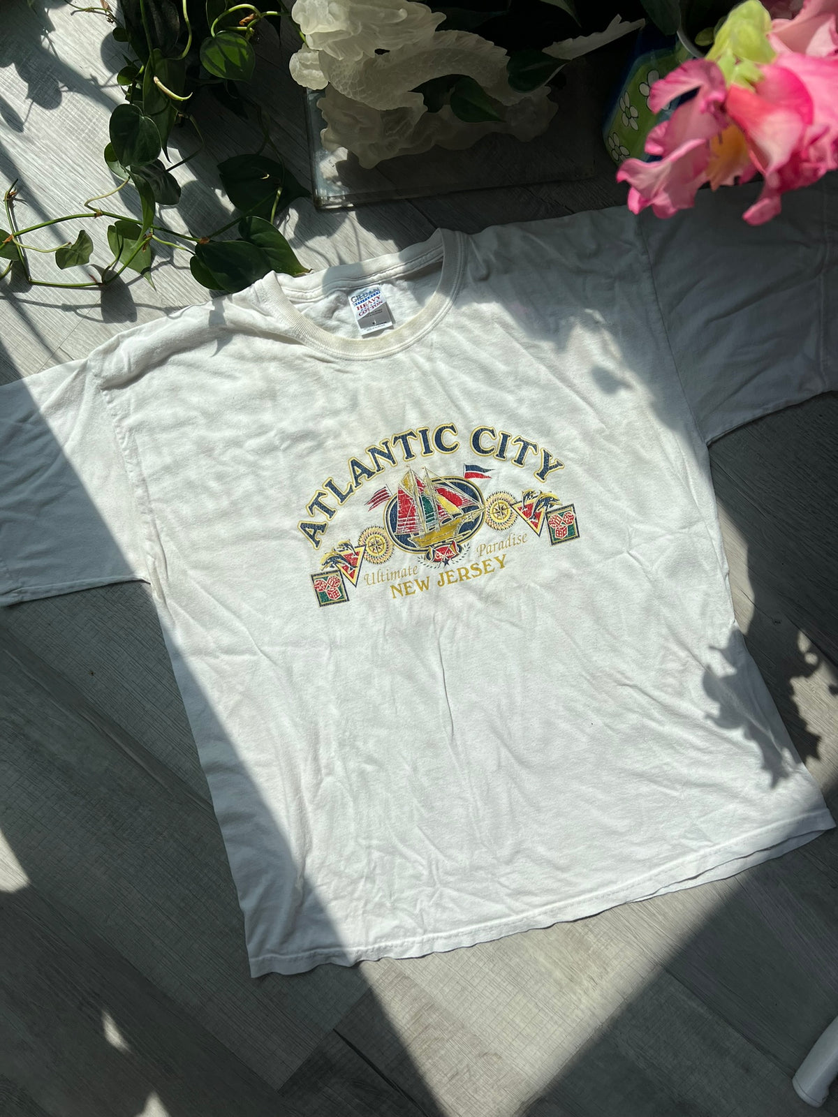 Vintage Atlantic City white T-shirt by Gildan, featuring classic design and Elektra Vintage branding, displayed on a hanger.