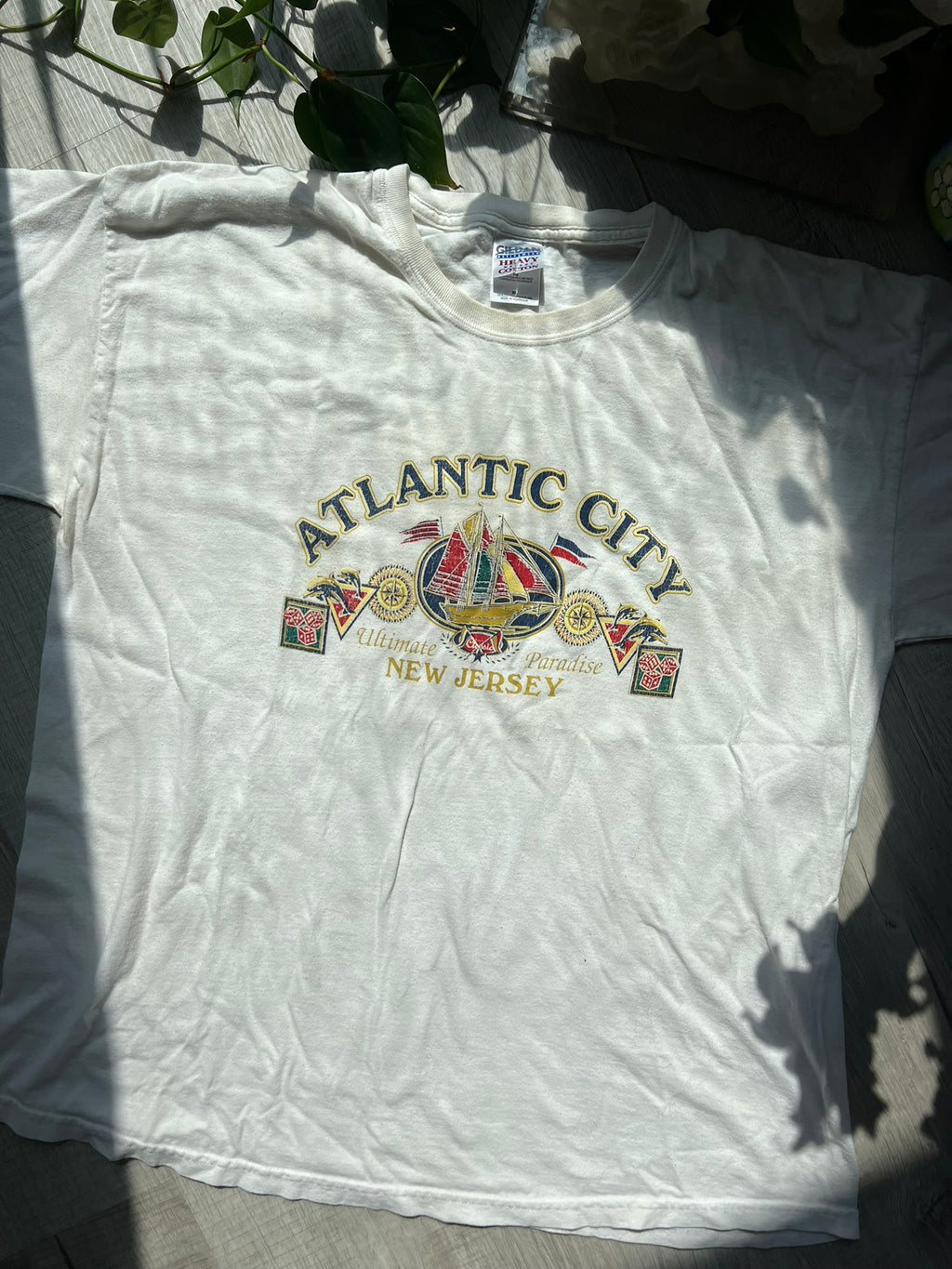 Vintage Atlantic City white T-shirt by Gildan featuring retro graphic design, displayed on a hanger.