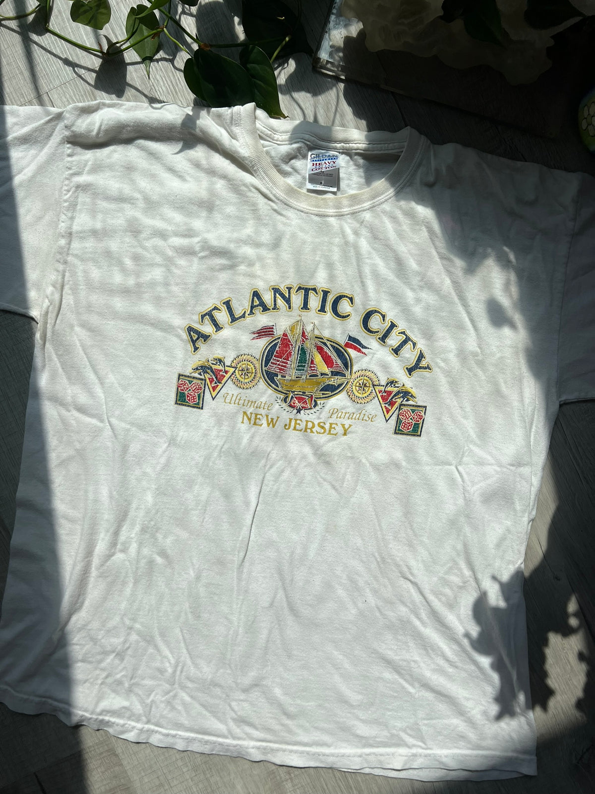 Vintage Atlantic City white T-shirt by Gildan featuring retro graphic design, displayed on a hanger.