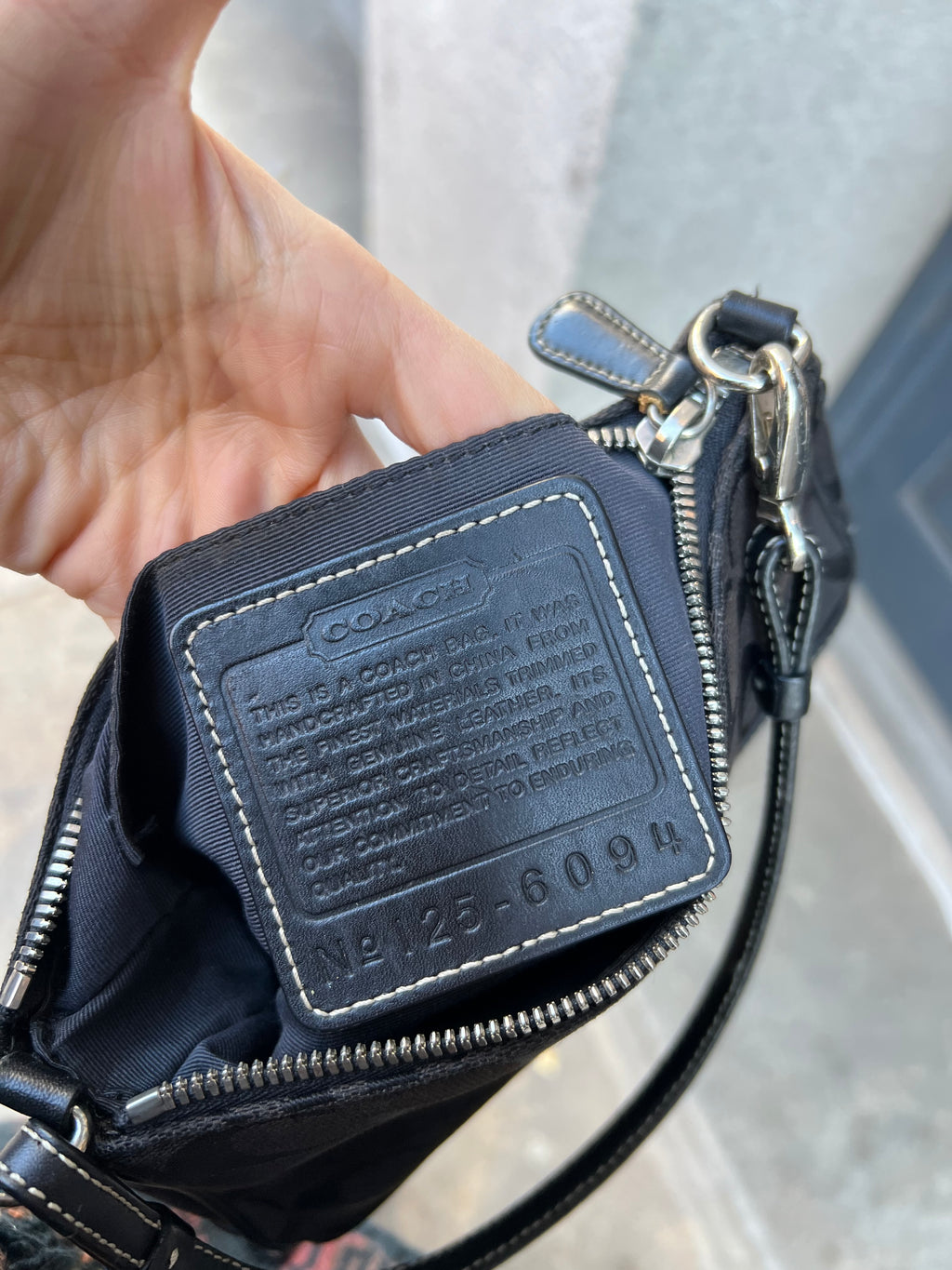 Vintage black signature Coach Demi shoulder bag with gold hardware and sleek design, featuring the Elektra Vintage logo.