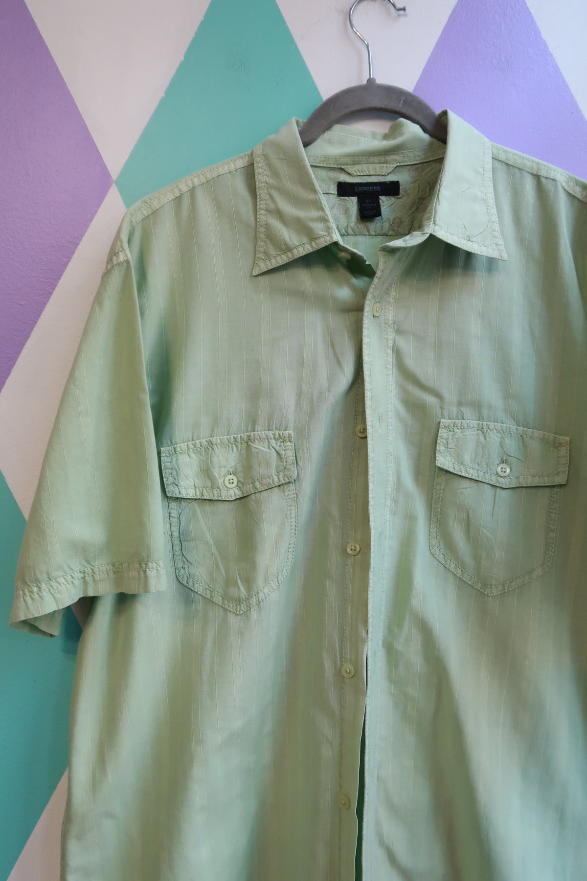 Men's vintage sage green short sleeve button-up shirt by Elektra Vintage, 2000s Express style, shown on a hanger.