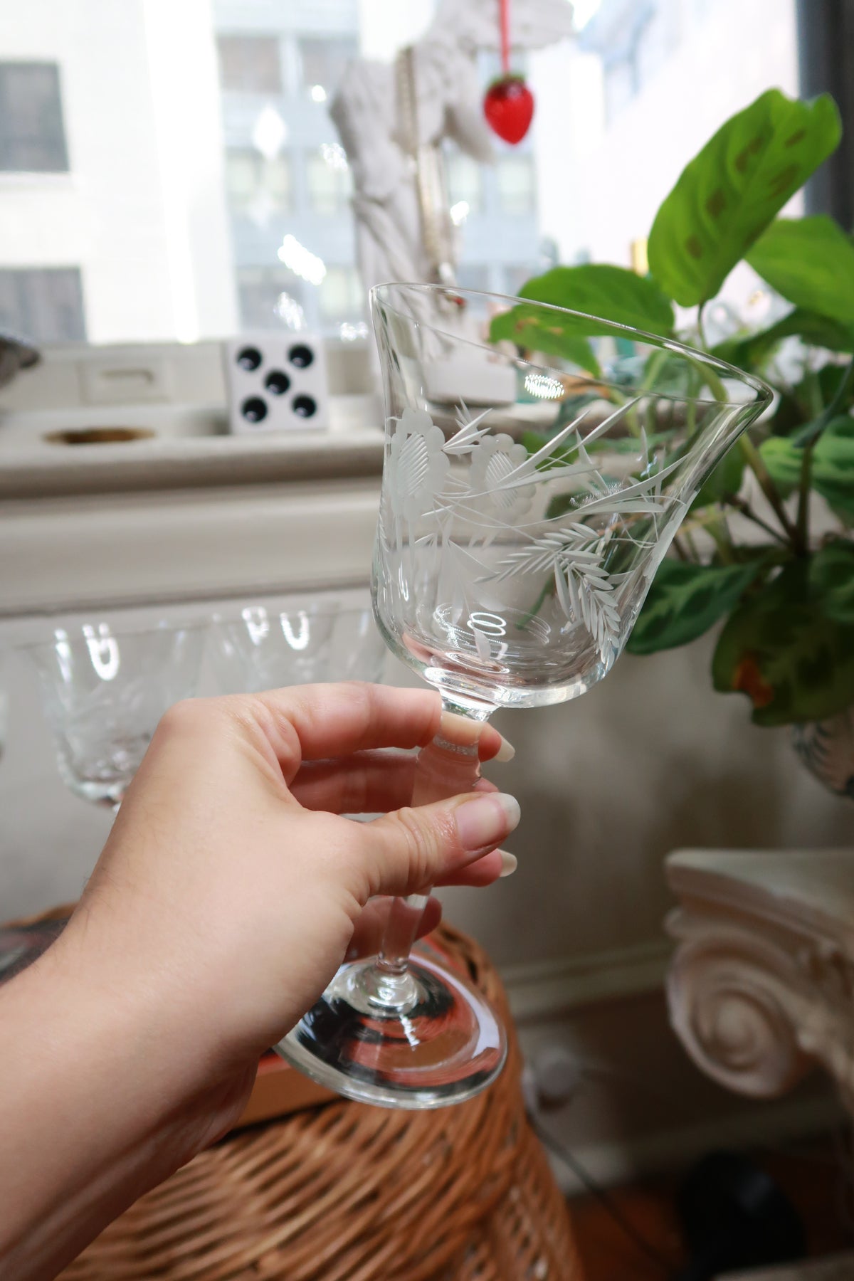Six vintage etched floral stemmed cocktail glasses from Elektra Vintage displayed on a table.