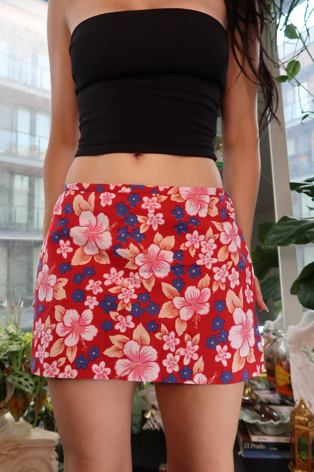 Vintage red Hawaiian floral mini skirt by Elektra Vintage with pink and blue tropical print, shown on a hanger.