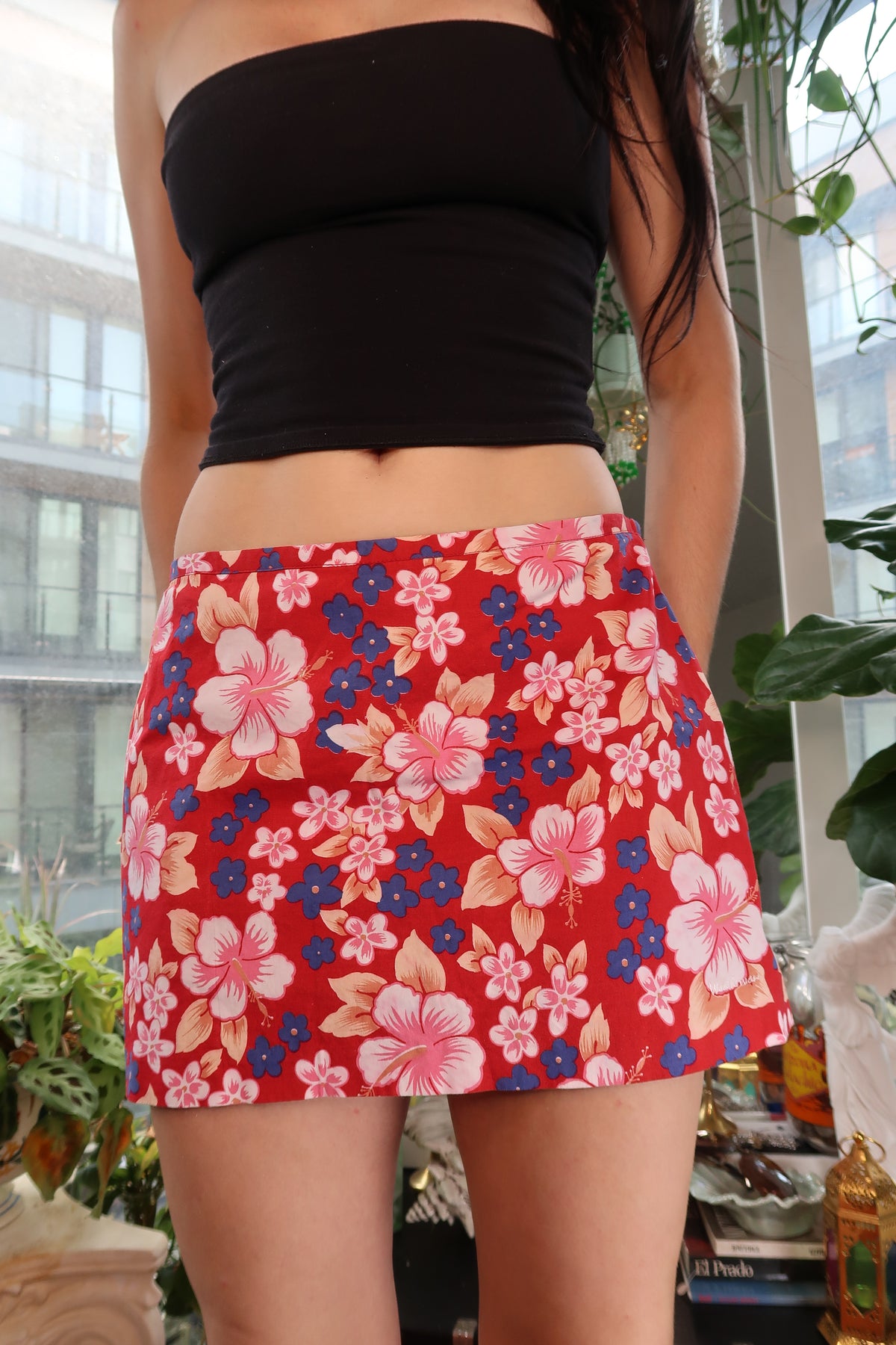 Vintage red Hawaiian floral mini skirt by Elektra Vintage with pink and blue tropical print, displayed on a hanger.