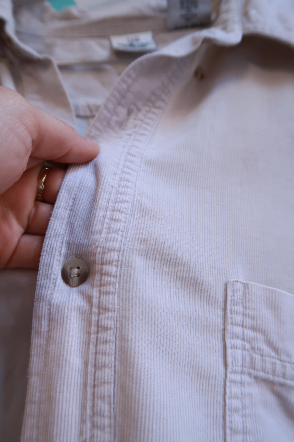 Beige men's vintage Disney Mickey Mouse embroidered long sleeve button-up shirt by Elektra Vintage, featuring Mickey Mouse on the front.