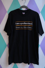 Load image into Gallery viewer, Black men's graphic T-shirt by Elektra Vintage with vintage 2000s "I Am a Professional. Do Not Try This at Home." print.
