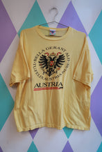 Load image into Gallery viewer, Elektra Vintage men's yellow T-shirt featuring an Austria crest and eagle graphic, vintage travel souvenir style.
