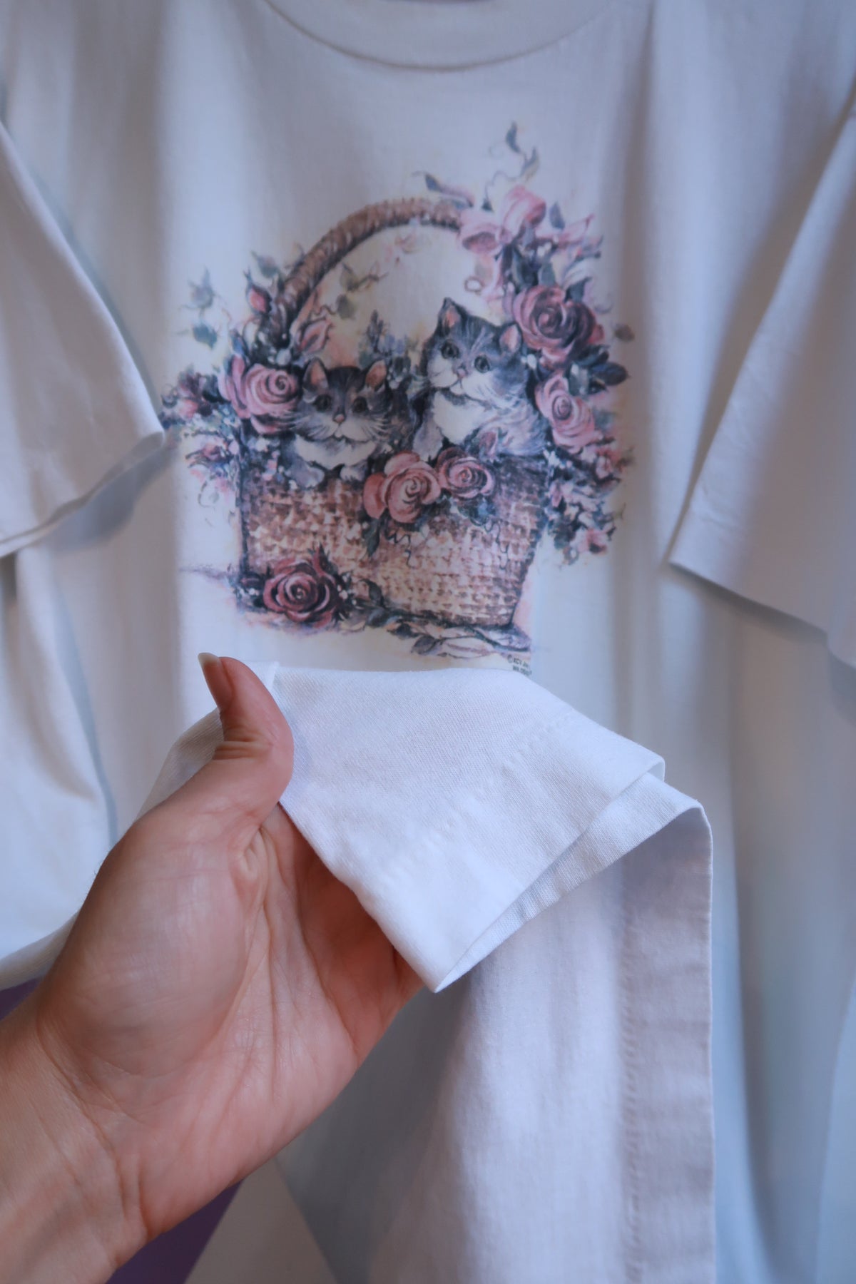 White men's vintage cottagecore T-shirt by Elektra Vintage featuring a floral graphic with kittens in a basket.