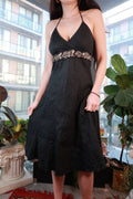 Vintage 2000s black halter dress with beaded embellishments and empire waist, perfect for Y2K-themed parties.