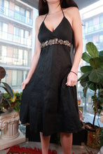 Load image into Gallery viewer, Vintage 2000s black halter dress with beaded embellishments and empire waist, perfect for Y2K-themed parties.
