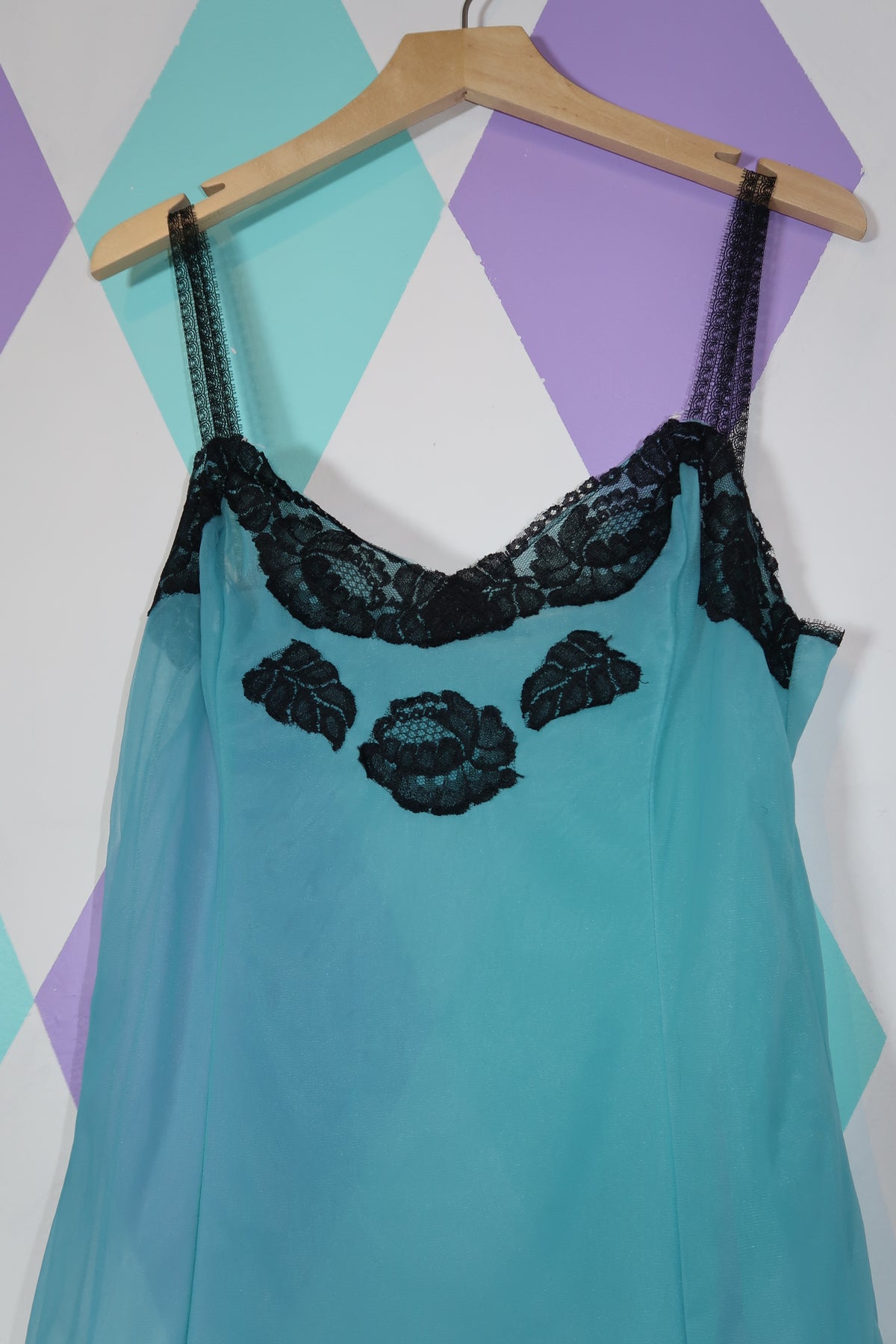 Vintage Elektra Vintage sheer blue slip dress with black lace detailing, featuring a delicate, flowing silhouette.