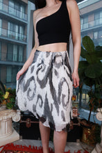 Load image into Gallery viewer, Vintage Tommy Hilfiger black and ivory ikat silk midi skirt with an abstract print, perfect for Y2K fashion enthusiasts.
