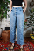 Women's vintage Y2K light wash cargo carpenter wide-leg jeans by Elektra Vintage, showing relaxed fit and detailed pockets.