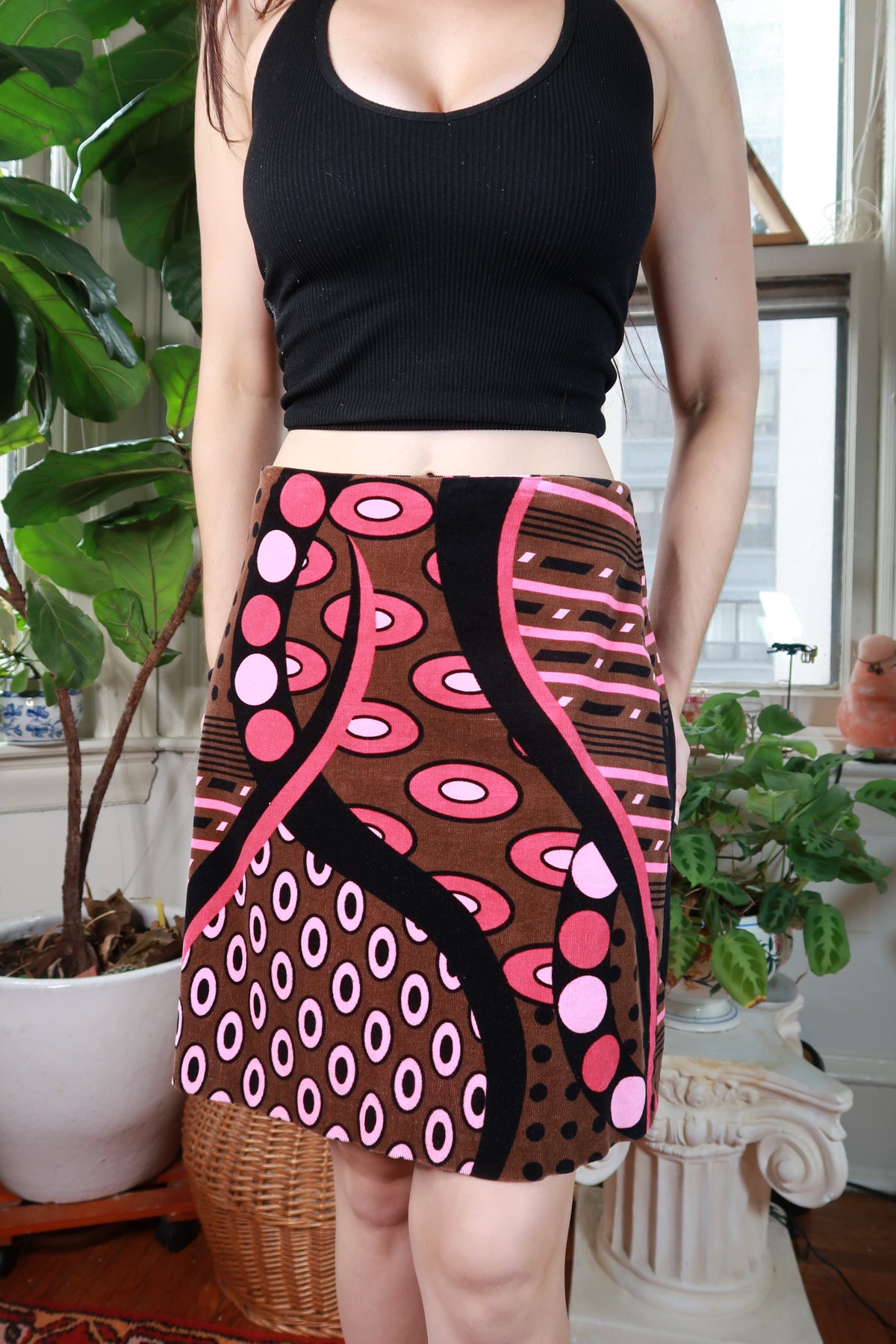 Eletra Vintage 2000s brown and pink abstract print corduroy midi skirt displayed on a hanger.