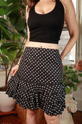 Black and white polka dot tiered ruffle midi skirt by Elektra Vintage, showcasing a vintage 2000s style with layered fabric and ruffle details.