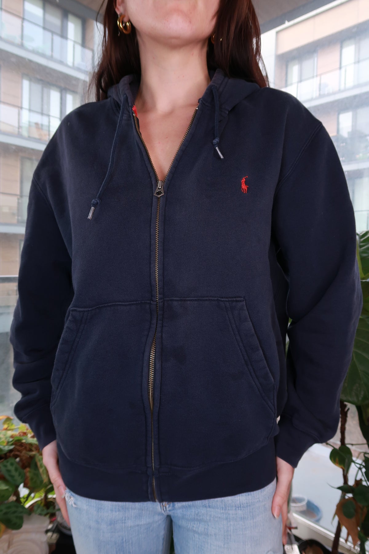 Vintage Polo Ralph Lauren navy zip-up hoodie featuring classic pony logo, styled casually on a neutral background.