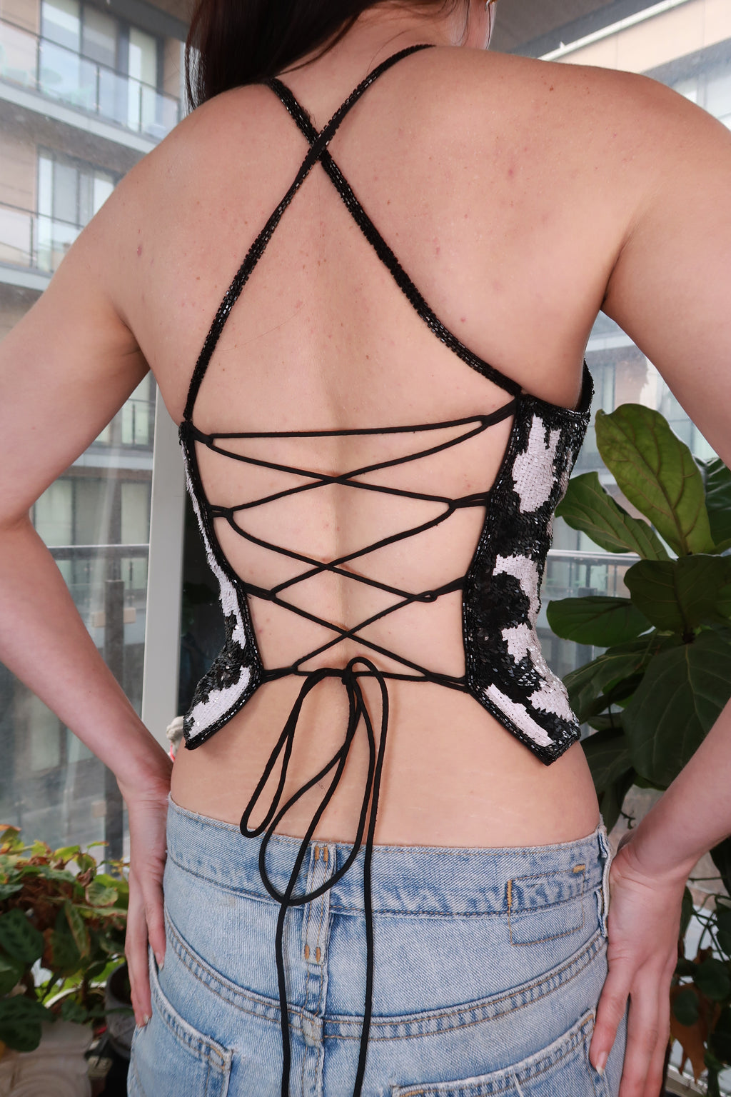 Vintage 2000s Elektra Vintage black and white sequin halter top with Y2K cow print design, perfect for parties.