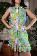 Load image into Gallery viewer, Vintage 60s-70s aqua floral sleeveless shift dress with ruffle hem by Elektra Vintage, displayed on a hanger.
