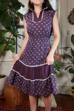 Load image into Gallery viewer, Vintage 70s purple floral prairie dress by Elektra Vintage, featuring lace trim and a tiered skirt, displayed on a hanger.

