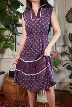 Load image into Gallery viewer, Vintage 70s purple floral prairie dress with lace trim and tiered skirt from Elektra Vintage, shown on a hanger.
