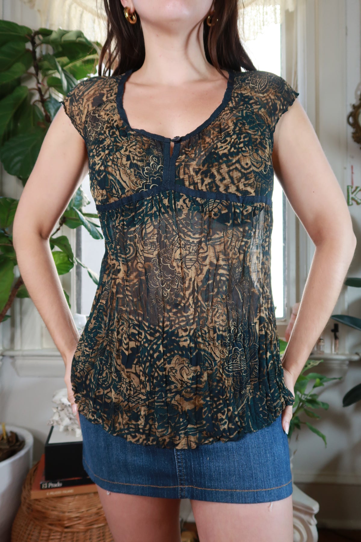 Vintage 2000s brown and black sheer pleated babydoll blouse for women by Elektra Vintage, showing the flowy fabric and detailed pleats.