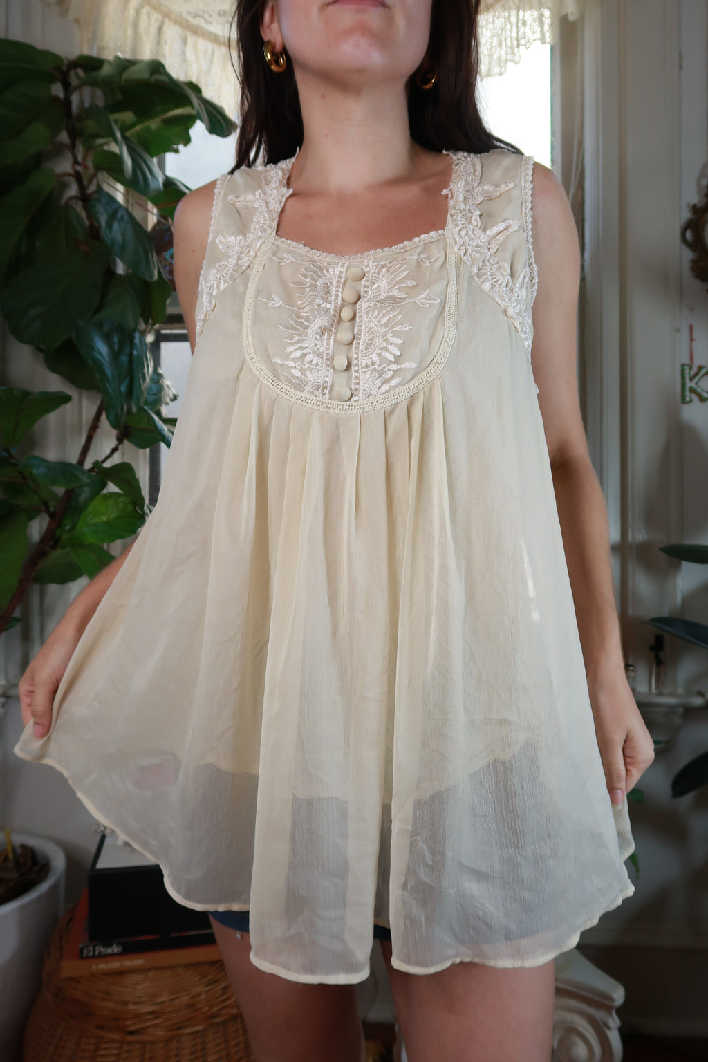 Vintage 2000s ivory sheer embroidered babydoll tunic top for women by Elektra Vintage, displayed on a hanger.