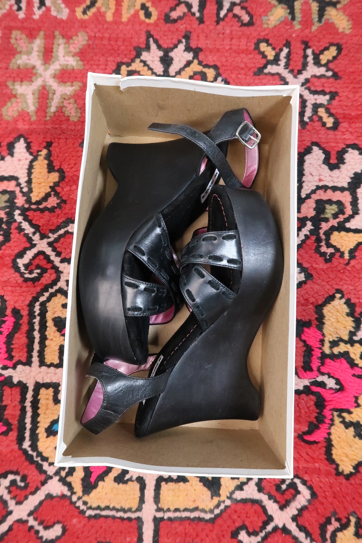 Deadstock vintage Steve Madden black platform wedges with Y2K strappy sandal design, featuring ankle straps and chunky heels.