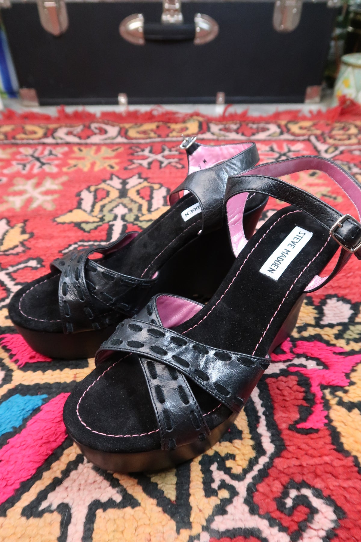 Deadstock vintage Steve Madden black platform wedge sandals with Y2K strappy design, shown on model's feet.