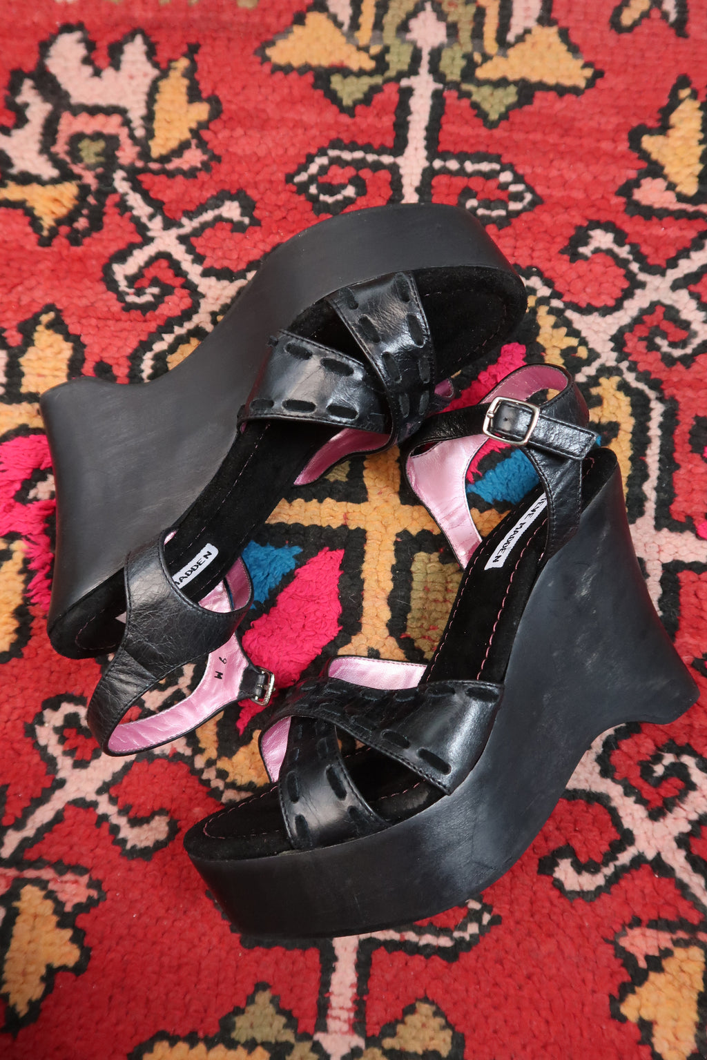 Black vintage Steve Madden platform wedges with Y2K strappy design, displayed on a neutral background.