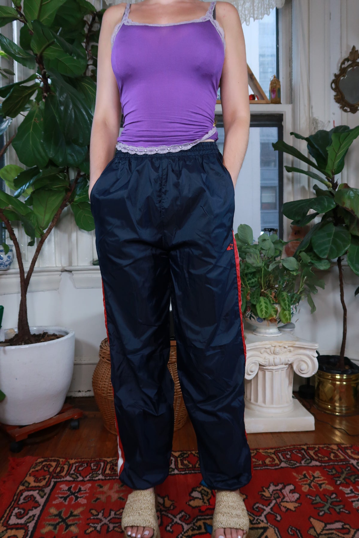 Women's navy blue track pants by Elektra Vintage, vintage Y2K Starter style, showing relaxed fit and elastic waistband.
