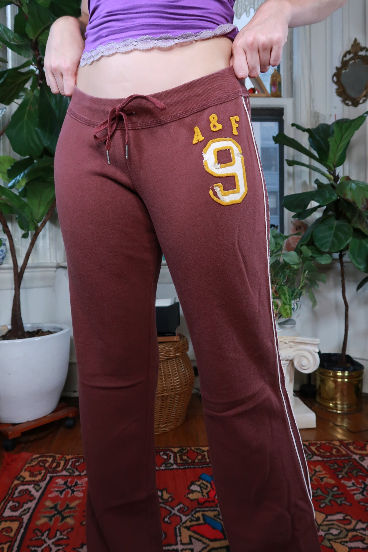 Vintage Y2K Abercrombie & Fitch burgundy low-rise sweatpants for women, made by Elektra Vintage, shown on a model.
