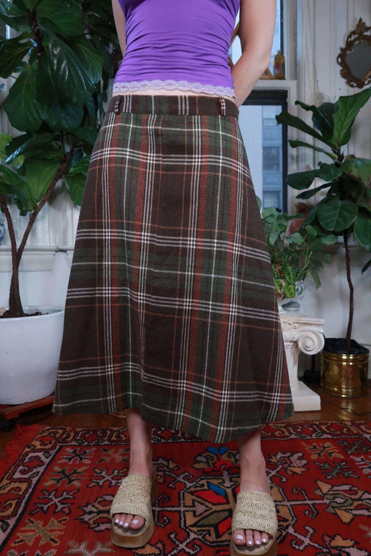 Vintage brown and green plaid midi skirt by Elektra Vintage, featuring a classic pattern and flowing midi length.