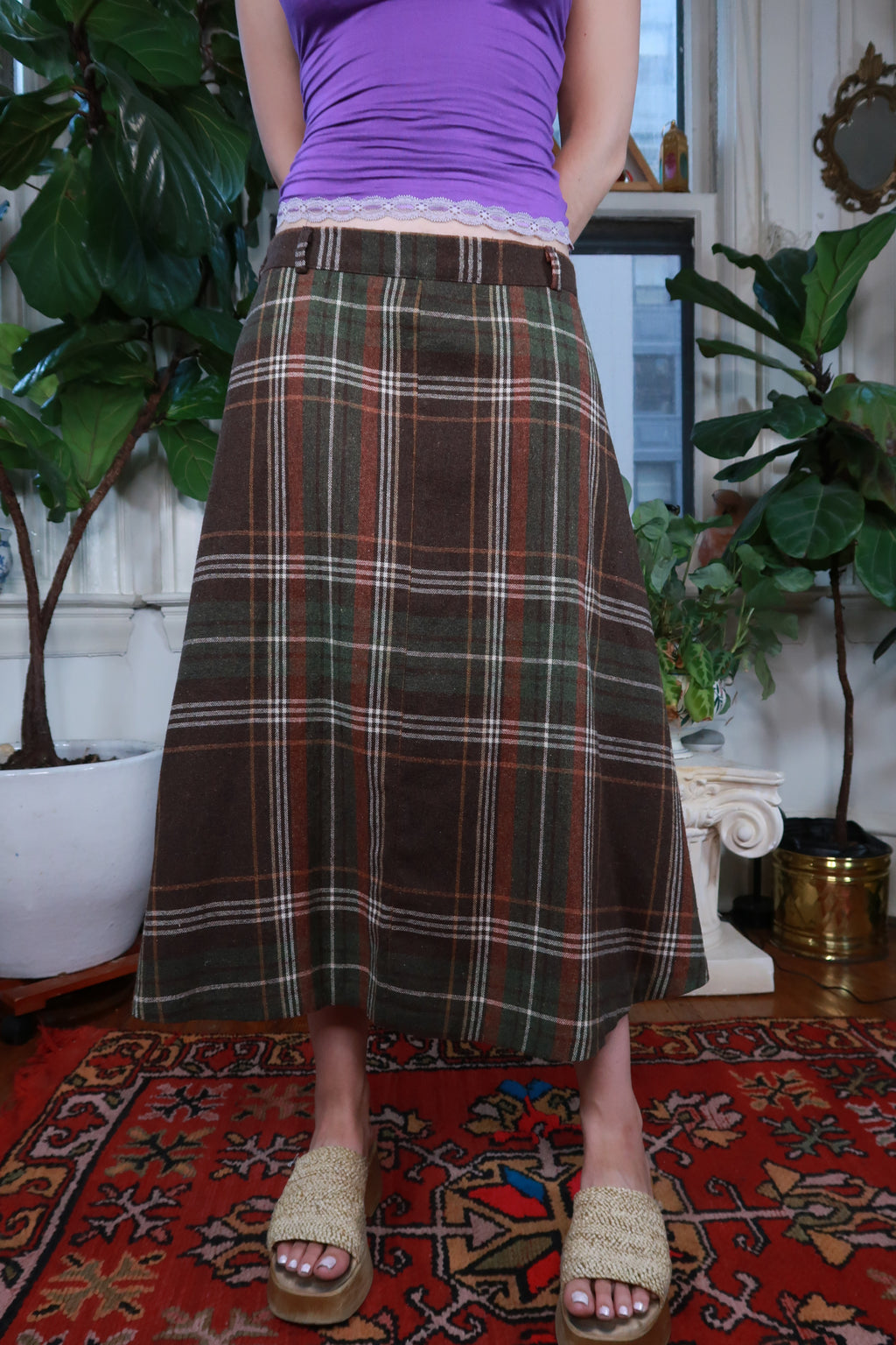 Elektra Vintage vintage brown and green plaid midi skirt with pleated design, shown on a model.