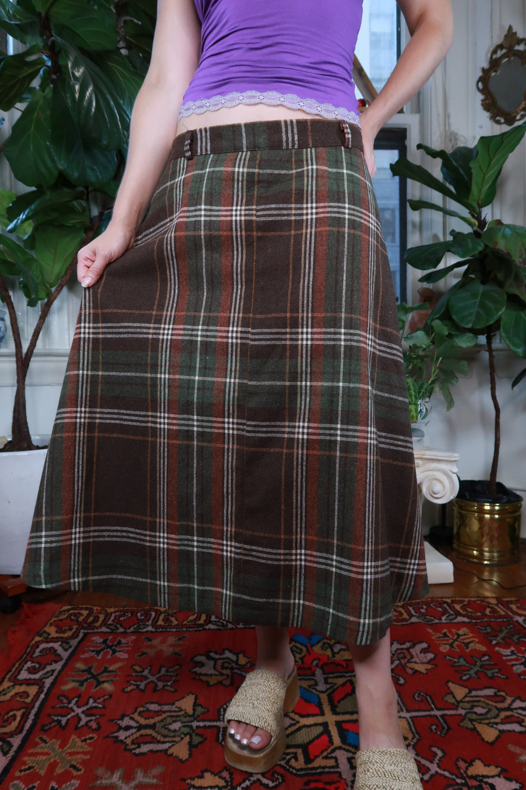 Vintage brown and green plaid midi skirt by Elektra Vintage, featuring a classic pattern and mid-length design.