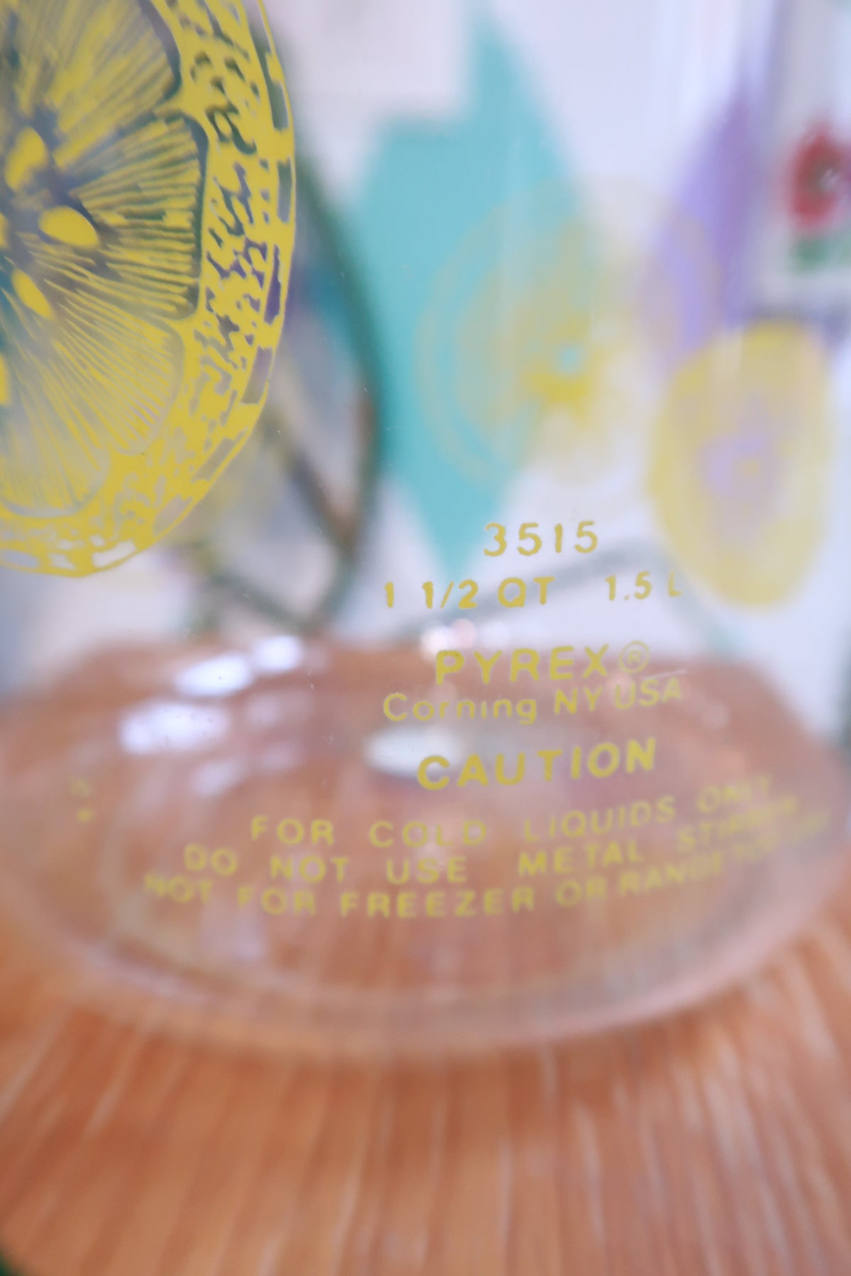 Vintage lemon print glass pitcher with yellow lid by Elektra Vintage, featuring retro citrus juice carafe design.
