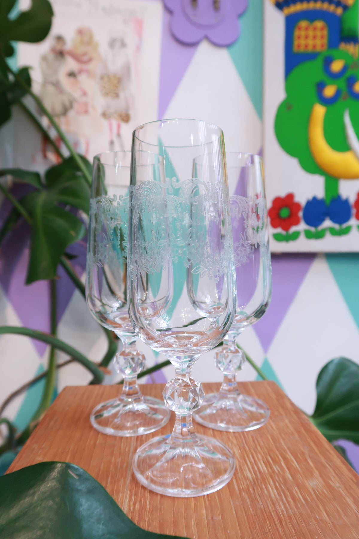 Elegant vintage etched crystal champagne flutes with faceted stems and floral designs by Elektra Vintage.