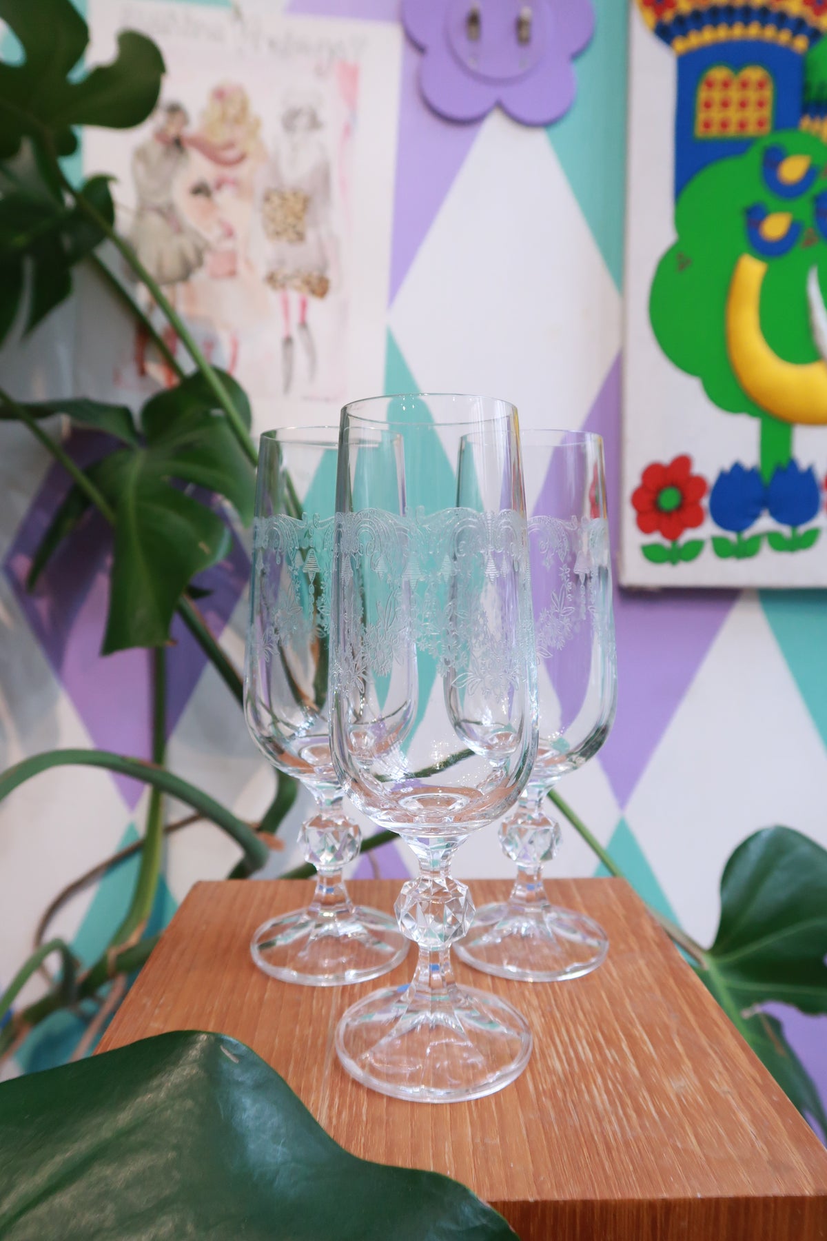Elegant vintage etched crystal champagne flutes with faceted stems and floral design by Elektra Vintage.