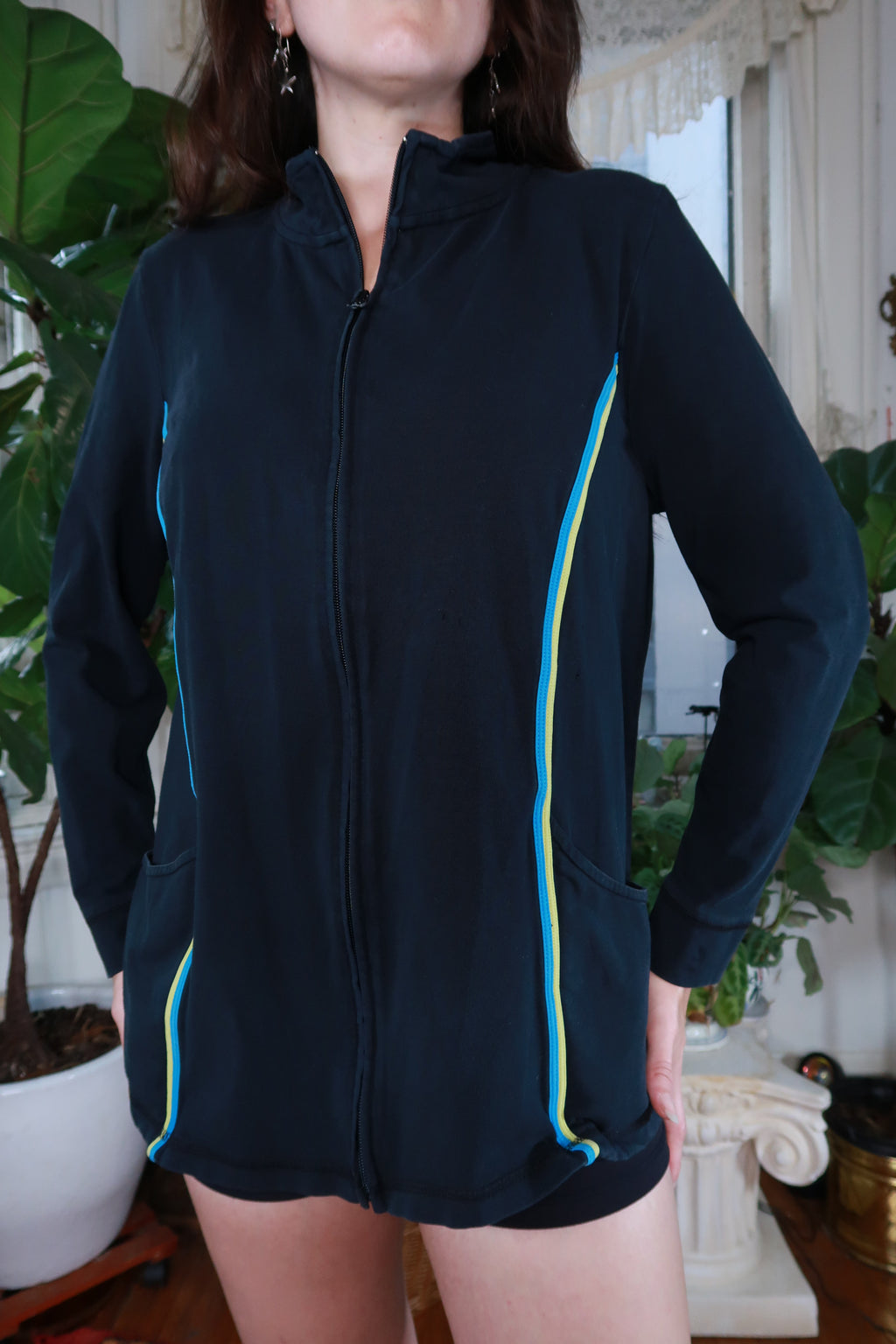 Women's navy blue zip-up track jacket by Elektra Vintage, vintage Y2K style, shown on a hanger.