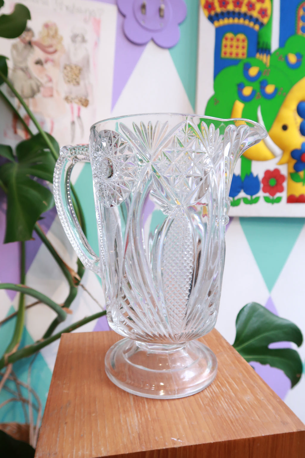Elektra Vintage pressed cut glass pitcher with starburst and fan pattern, pedestal design, perfect for serving water or beverages.