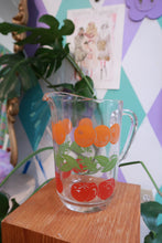 Load image into Gallery viewer, Vintage glass pitcher with a tomato and orange fruit print, retro Elektra Vintage juice pitcher with colorful fruit graphic design.
