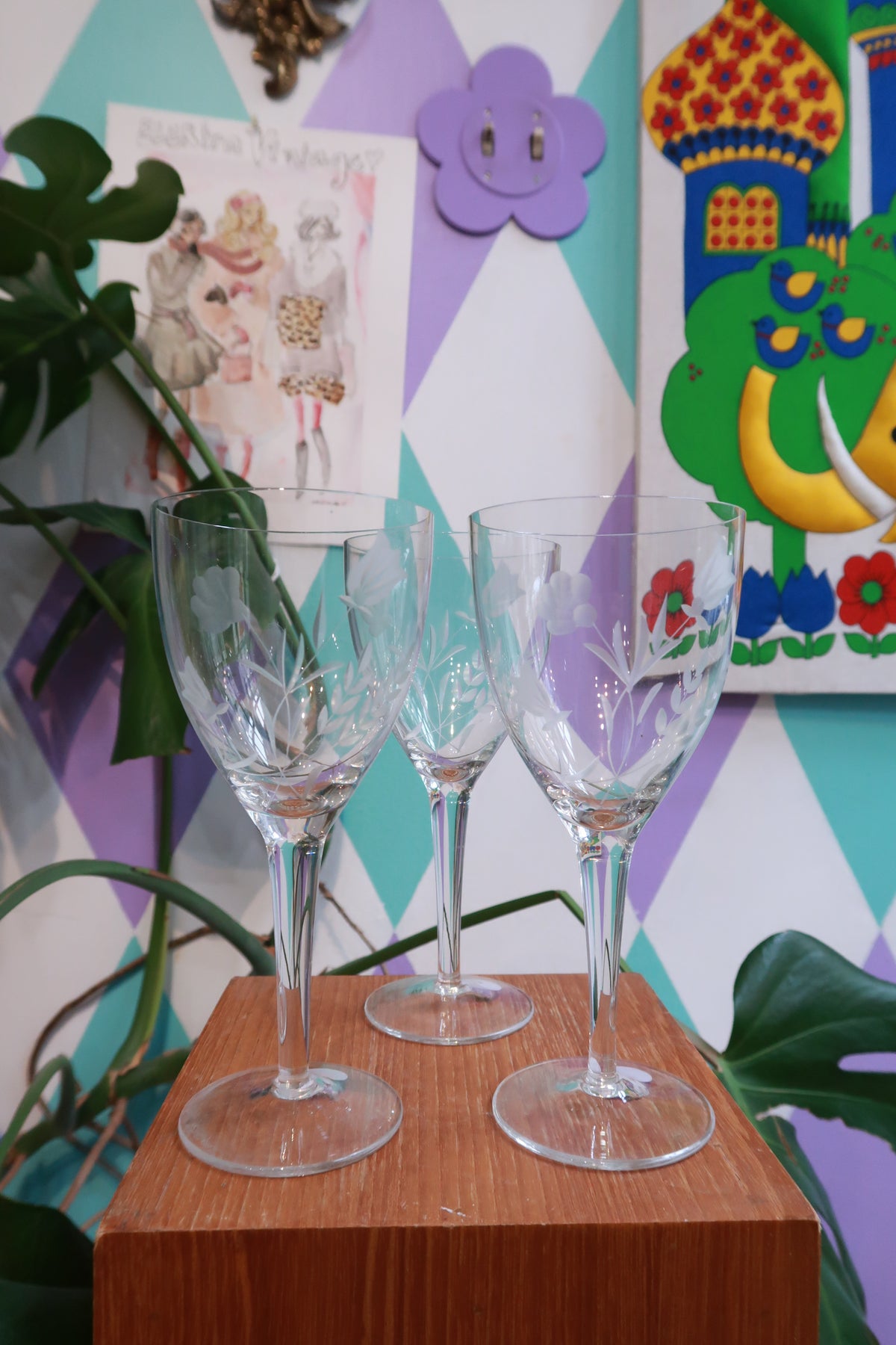Set of three vintage etched floral wine glasses by Elektra Vintage with frosted flower designs on clear glass stemware.