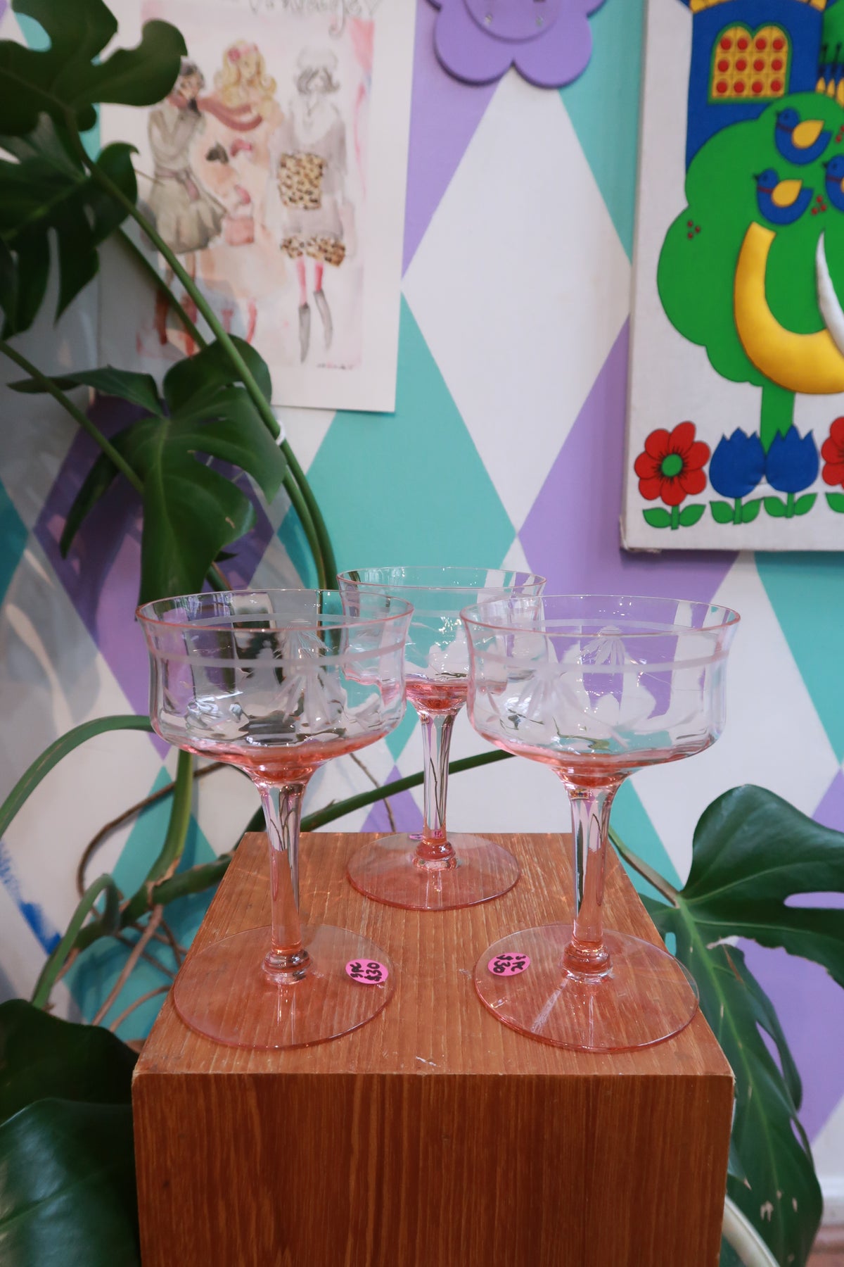 Set of three Elektra Vintage pink stem coupe glasses with etched floral design, blush glass champagne coupés for elegant dining.